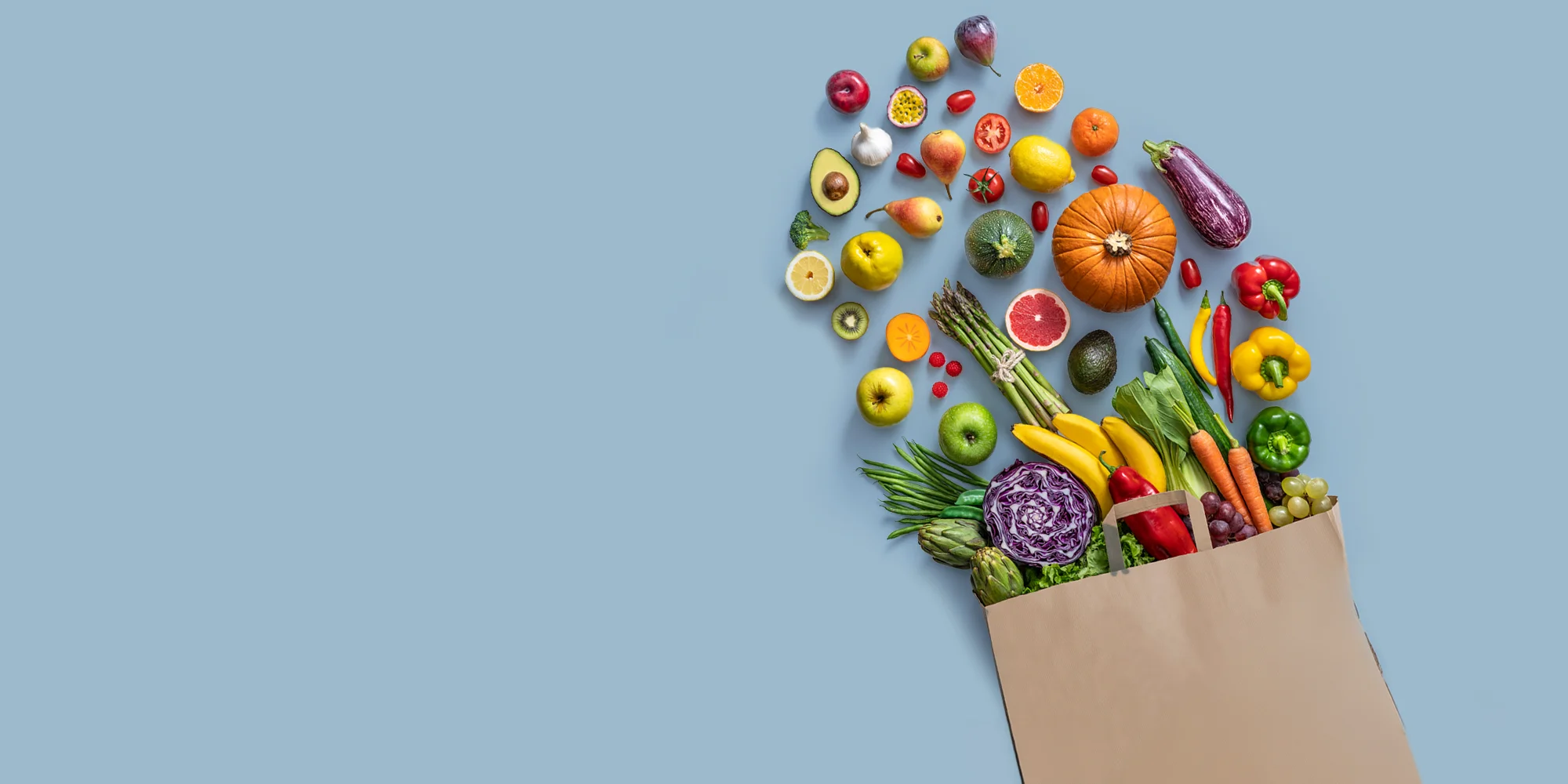 Fresh colorful fruits and vegetables spilling from a grocery bag, representing ThinWell Clinic’s focus on balanced nutrition and healthy eating in Columbus, GA.
