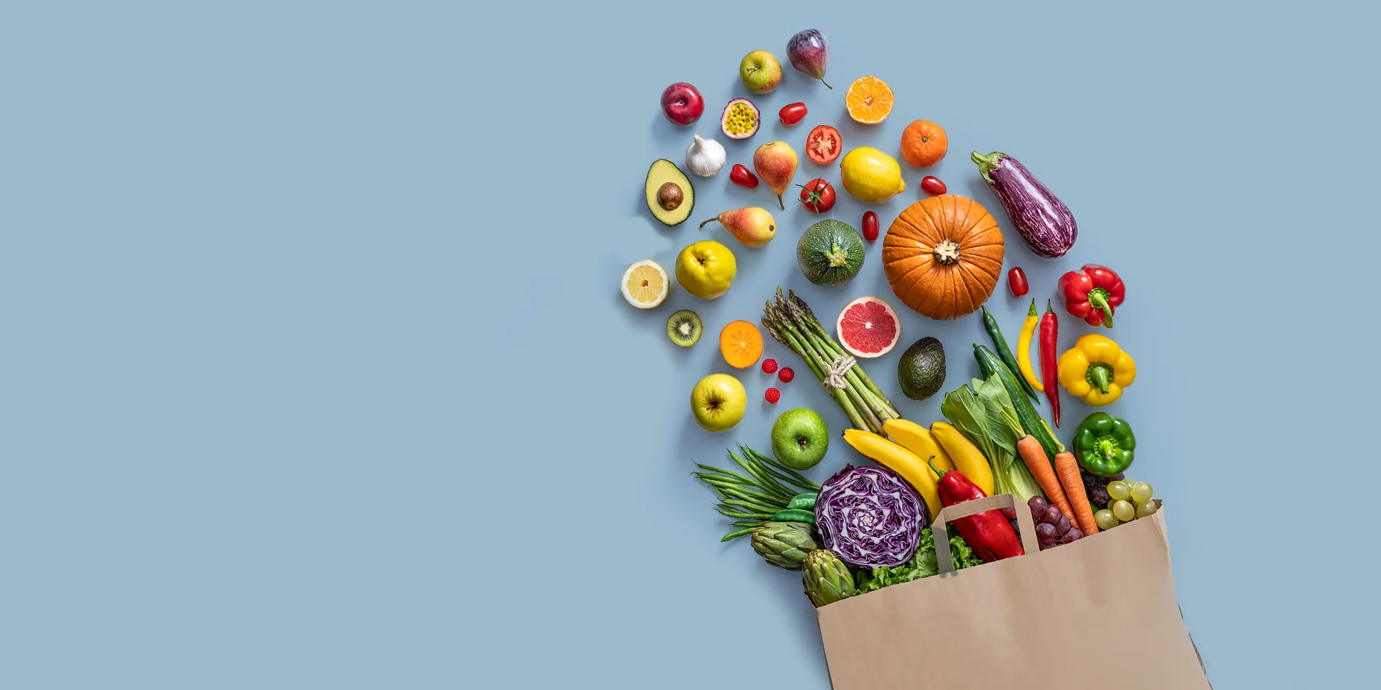 Fresh colorful fruits and vegetables spilling from a grocery bag, representing ThinWell Clinic’s focus on balanced nutrition and healthy eating in Columbus, GA.